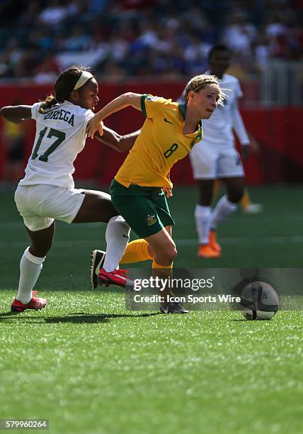 June 2015 Australia's Amy Rodriguez goes around Nigeria's Fransica Ordega during the Australia vs Nigeria game at the Investors Group Field in...