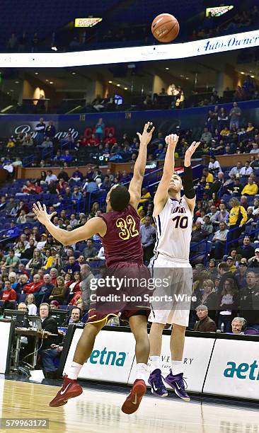 Northern Iowa forward Seth Tuttle puts up a three point shot over Loyola forward Christian Thomas during a semi-final round Missouri Valley...