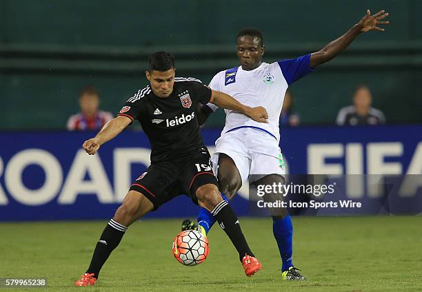 Jairo Arrieta of D.C United shields the ball from Orlando McBayne of Montego Bay United during a CONCACAF Champions League match at RFK Stadium, in...