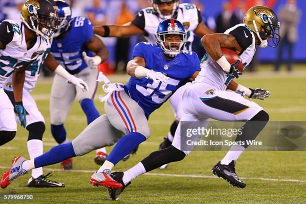 New York Giants defensive back Josh Gordy tries to tackle Jacksonville Jaguars wide receiver Rashad Greene during the first quarter of the game...