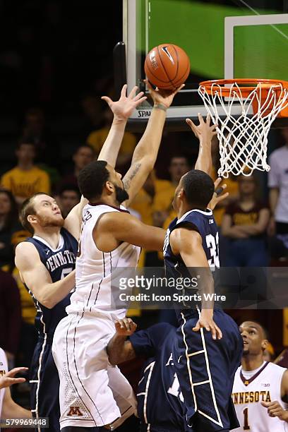 March 8, 2015 Gophers forward Maurice Walker goes up for a shot against Penn State Nittany Lions forward Donovon Jack and guard Shep Garner during...