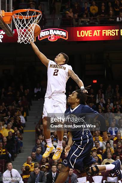 March 8, 2015 Gophers guard Nate Mason shoots a layup while being guarded by Penn State Nittany Lions forward Brandon Taylor during the second half...