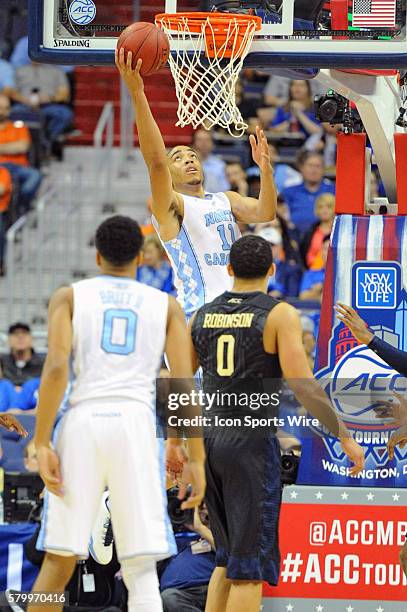 North Carolina Tar Heels forward Brice Johnson scores against Pittsburgh Panthers guard James Robinson in the quarterfinals of the ACC Tournament at...