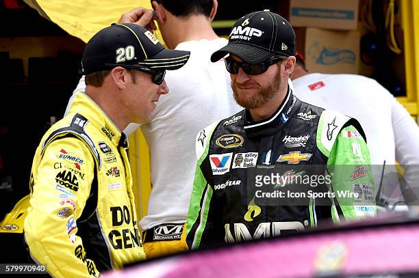 Matt Kenseth chatting with Dale Earnhardt Jr prior to the running of the Quicken Loans 400 NASCAR Sprint Cup Series race at Michigan International...