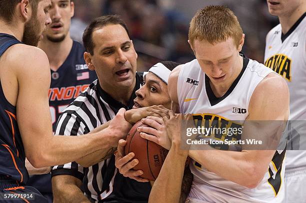 Iowa Hawkeyes guard Mike Gesell battles for a held ball during the men's Big Ten Tournament basketball game between the Illinois Fighting Illini and...