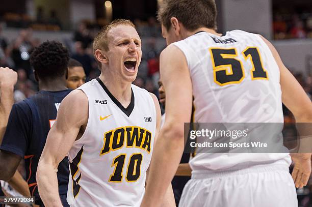 Iowa Hawkeyes guard Mike Gesell celev\brates with Iowa Hawkeyes forward Nicholas Baer during the men's Big Ten Tournament basketball game between the...