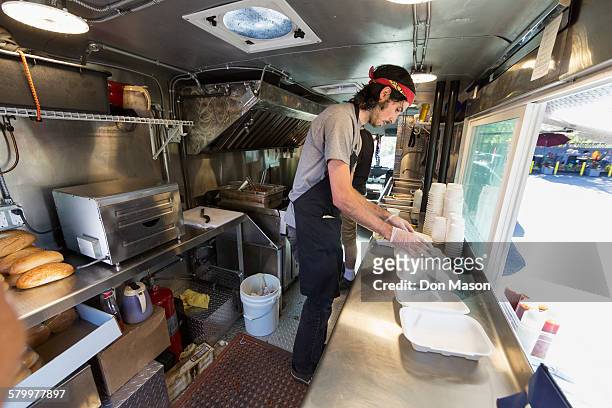 Caucasian chef working in food truck kitchen