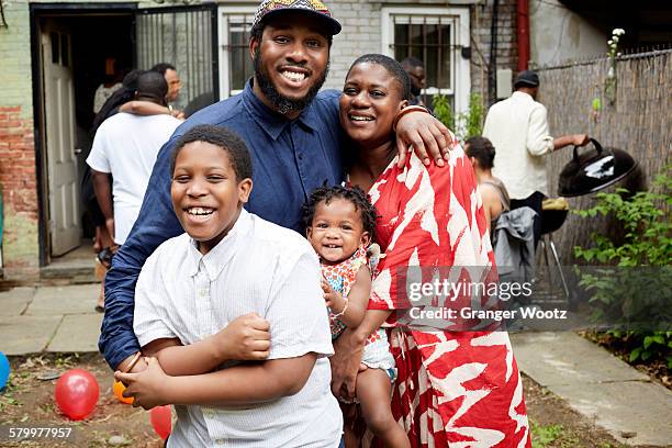 Family hugging at backyard barbecue