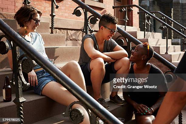 friends relaxing on front stoop - brooklyn new york stockfoto's en -beelden