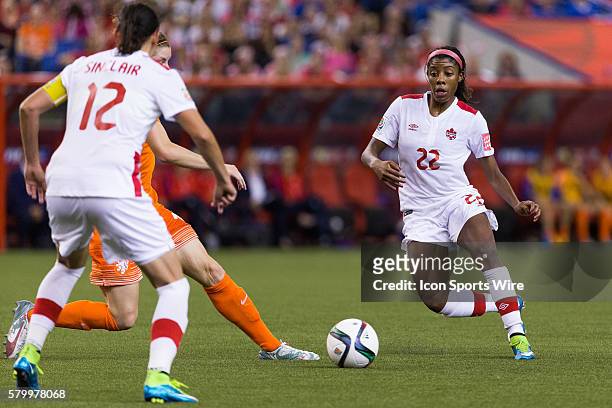 Canada midfielder Ashley Lawrence makes a pass to teammate forward Christine Sinclair during the 2015 FIFA Women's World Cup Group A match between...