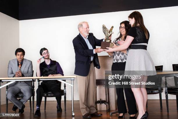 debate team receiving award on stage - the asian awards 2015 fotografías e imágenes de stock