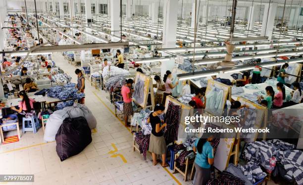 high angle view of workers in garment factory - garment stock pictures, royalty-free photos & images