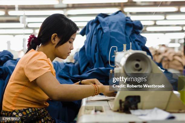 asian worker sewing clothing in garment factory - garment stock pictures, royalty-free photos & images