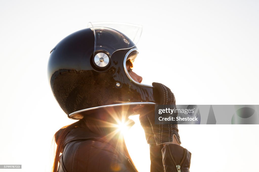Caucasian woman wearing motorcycle helmet