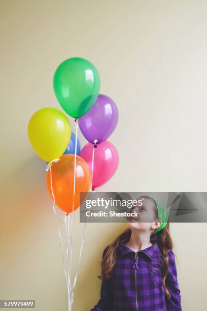 caucasian girl holding bunch of balloons - decorative balloons ストックフォトと画像