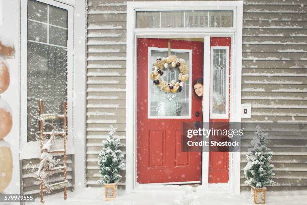 caucasian woman opening door to snow - portrait winter stock pictures, royalty-free photos & images