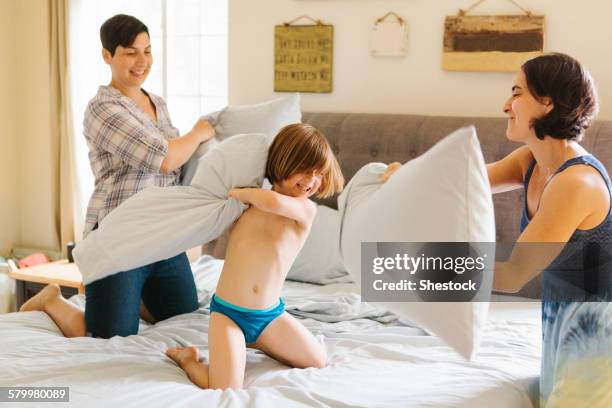 caucasian family having pillow fight in bedroom - panties girls stock pictures, royalty-free photos & images