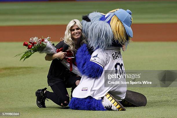 Tampa Bay Rays mascot Raymond presents former Rays play Ben Zobrist wife Julianna with flowers and gives her a kiss after she sang the national...