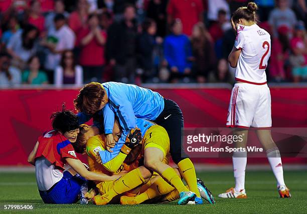 Goalkeeper Kim Jungmi of Korea Republic is congratulated by team mates after the FIFA 2015 Women's World Cup Group E match between Korea and Spain at...
