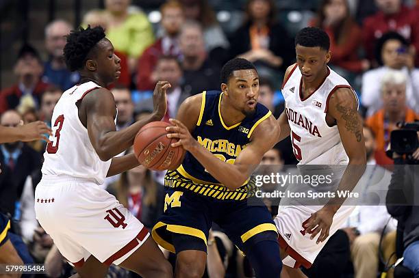 Michigan Wolverines guard Zak Irvin battles with Indiana Hoosiers forward OG Anunoby and Indiana Hoosiers forward Troy Williams in action during a...