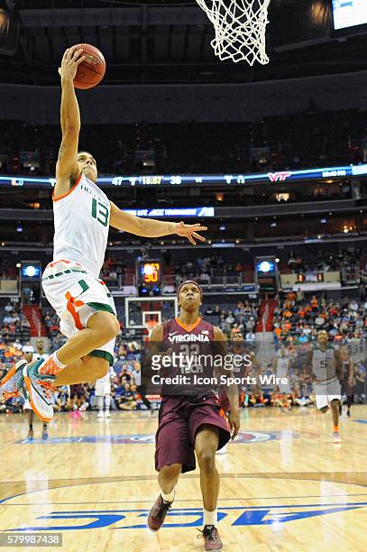 Miami Hurricanes guard Angel Rodriguez scores on a fast break against Virginia Tech Hokies forward Zach LeDay in the quarterfinals of the ACC...