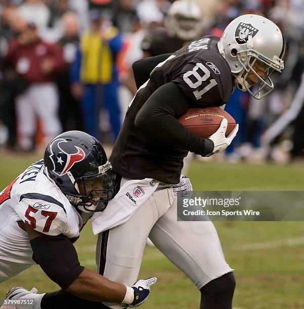 Houston Texans linebacker Kevin Bentley tackles Oakland Raiders wide receiver Chaz Schilens on Sunday, December 21, 2008 at McAfee Coliseum in...