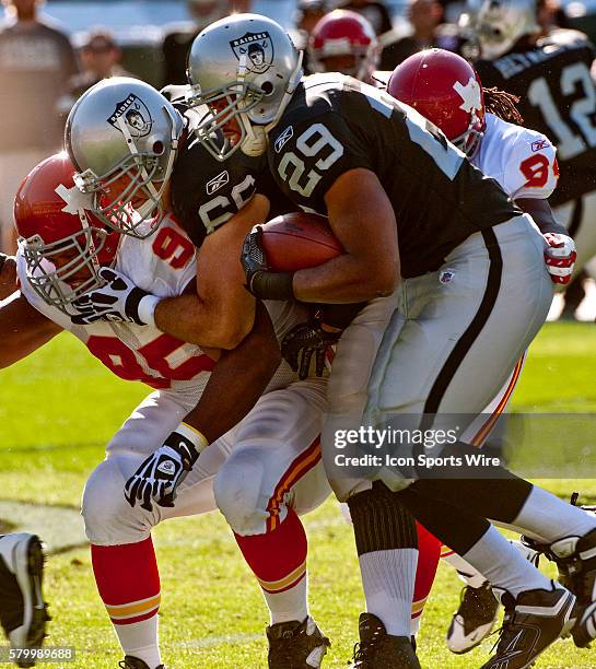 Oakland Raiders guard Cooper Carlisle helps running back Michael Bush get by Kansas City Chiefs defensive tackle Ron Edwards on Sunday, November 15,...