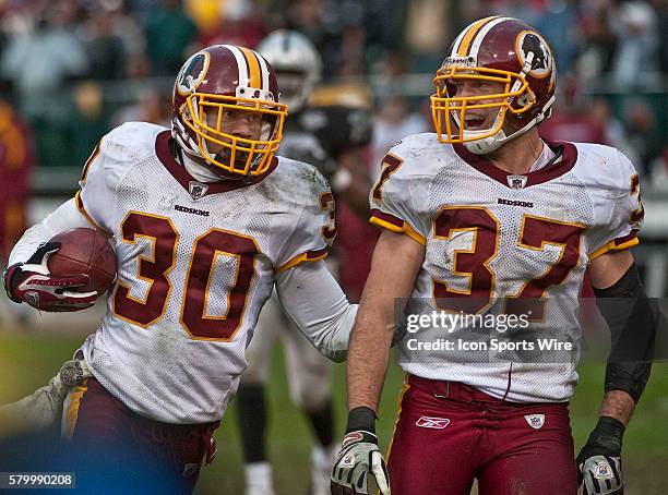 Washington Redskins safety LaRon Landry celebrates with safety Reed Doughty after intercepting Oakland Raiders quarterback JaMarcus Russell's pass on...