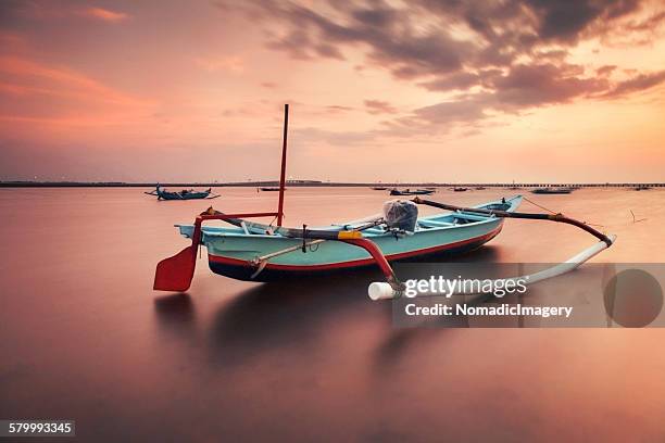 calm waters - outrigger stock pictures, royalty-free photos & images