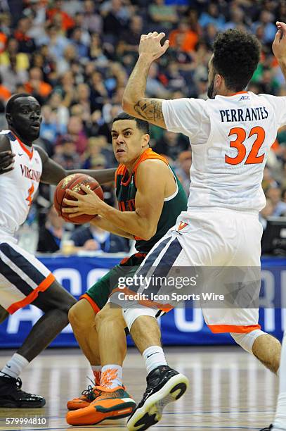 Miami Hurricanes guard Angel Rodriguez drives against Virginia Cavaliers guard Marial Shayok and guard London Perrantes in the semifinal of the ACC...