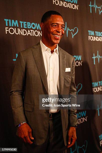Former NFL and NCAA running back and 1981 Heisman winner Marcus Allen poses on the red carpet during the during the Tim Tebow Foundation Celebrity...