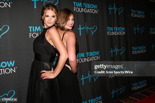 Country singer Kristy Lee Cook and a friend pose on the red carpet during the during the Tim Tebow Foundation Celebrity Gala at the TPC Sawgrass...