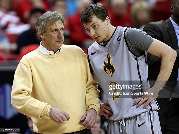 Wyoming Cowboys head coach Larry Shyatt talks with guard Riley Grabau during the second half of the Mountain West Men's Basketball tournament game...