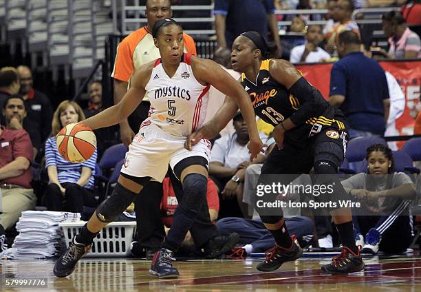 Karima Christmas of the Tulsa Shock tries to stop the progress of Kayla Thornton of the Washington Mystics during a WNBA game at Verizon Center, in...