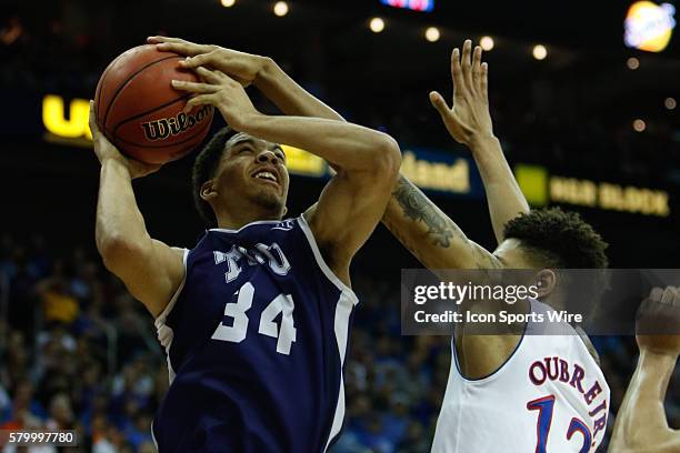 Kansas guard Kelly Oubre blocks the shot of TCU guard Kenrich Williams during the Thursday game between the Kansas Jayhawks and TCU Horned Frogs in...