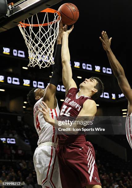 Dayton Flyers guard Charles Cooke blocks shot by Saint Joseph's Hawks forward Pierfrancesco Oliva during the 1st half of the NCAA Atlantic 10...