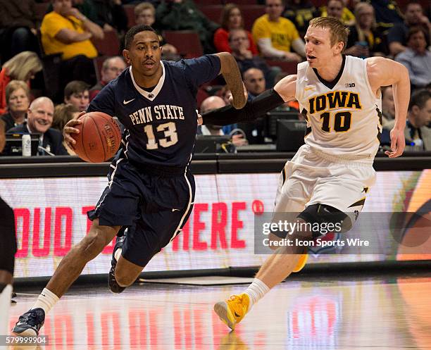 Iowa's Mike Gesell defends Penn State's Geno Thorpe during the Big Ten Men's Basketball Tournament game between the Penn State Nittany Lions and the...