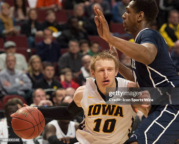 Penn State's Jordan Dickerson defends against Iowa's Mike Gesell during the Big Ten Men's Basketball Tournament game between the Penn State Nittany...