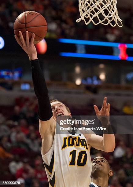 Penn State's Geno Thorpe fouls Iowa's Mike Gesell during the Big Ten Men's Basketball Tournament game between the Penn State Nittany Lions and the...