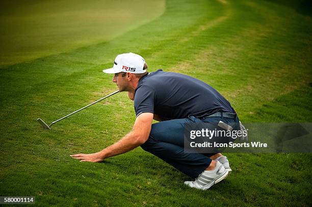 Dustin Johnson eyes his shot on the 18th green during the Final Round of the PGA - World Golf Championships-Cadillac Championship at Trump National...