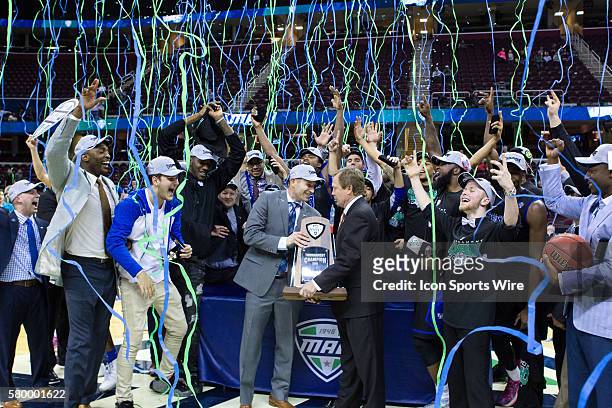 Mid-American Conference Commissioner Jon Steinbrecher presents the MAC Men's Basketball Tournament Championship trophy to Buffalo Bulls head coach...
