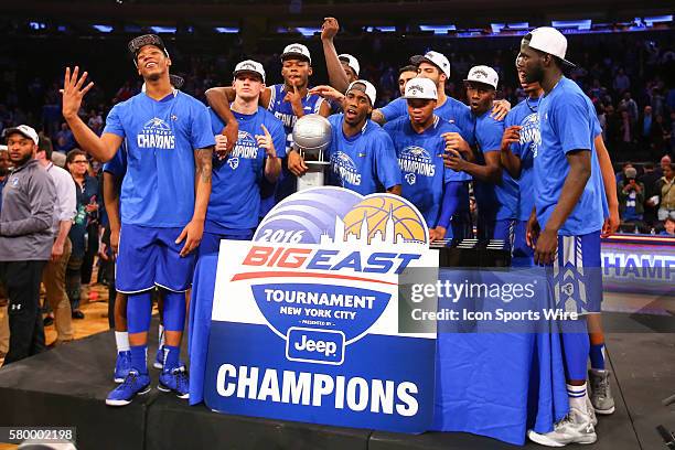 The Seton Hall Pirates pose with the tournament championship trophy after winning the Big East Tournament Final between the Villanova Wildcats and...