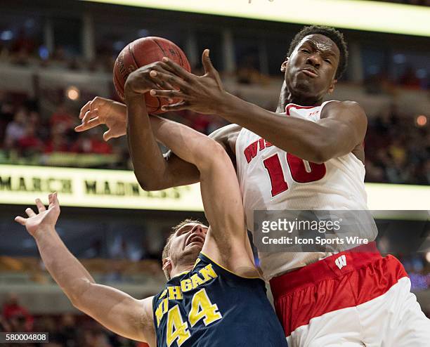 Michigan's Max Bielfeldt and Wisconsin's Nigel Hayes challenge for a rebound during the Big Ten Men's Basketball Tournament game between the...