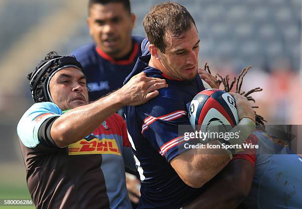 Zach Test of the USA Eagles is hauled down by Mark Lambert of Harlequins during an international rugby friendly match at PPL Park, in Chester, PA....