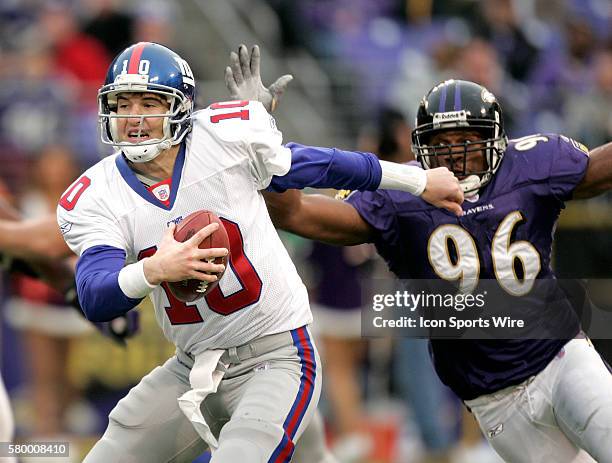 Giants quarterback Eli Manning is bought down by Adalius Thomas during the second half of a NFL football game between the Balitmore Ravens and the...