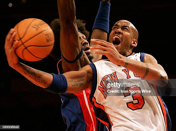 Stephon Marbury goes up for a basket against Ben Wallace of the Detroit Pistons in NBA Basketball action.