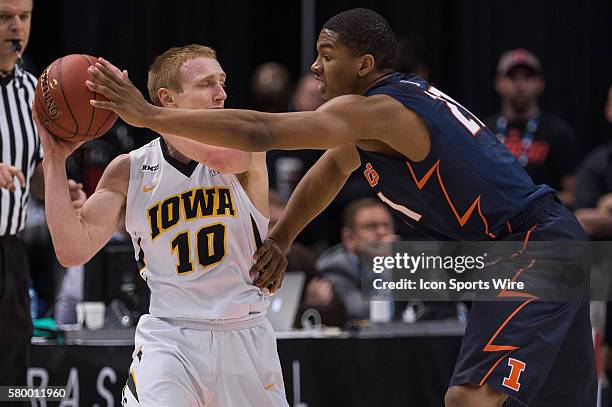 Illinois Fighting Illini guard Malcolm Hill defends Iowa Hawkeyes guard Mike Gesell during the men's Big Ten Tournament basketball game between the...