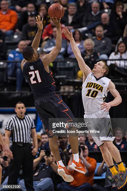 Illinois Fighting Illini guard Malcolm Hill shoots over Iowa Hawkeyes guard Mike Gesell during the men's Big Ten Tournament basketball game between...