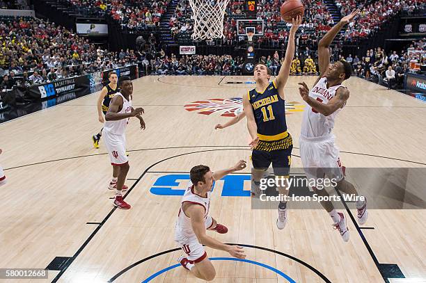 Indiana Hoosiers forward Troy Williams defends Michigan Wolverines guard Andrew Dakich during the men's Big Ten Tournament basketball game between...