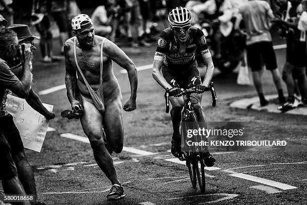 Ireland's Daniel Martin rides as fans cheer during the 146 km nineteenth stage of the 103rd edition of the Tour de France cycling race on July 22,...